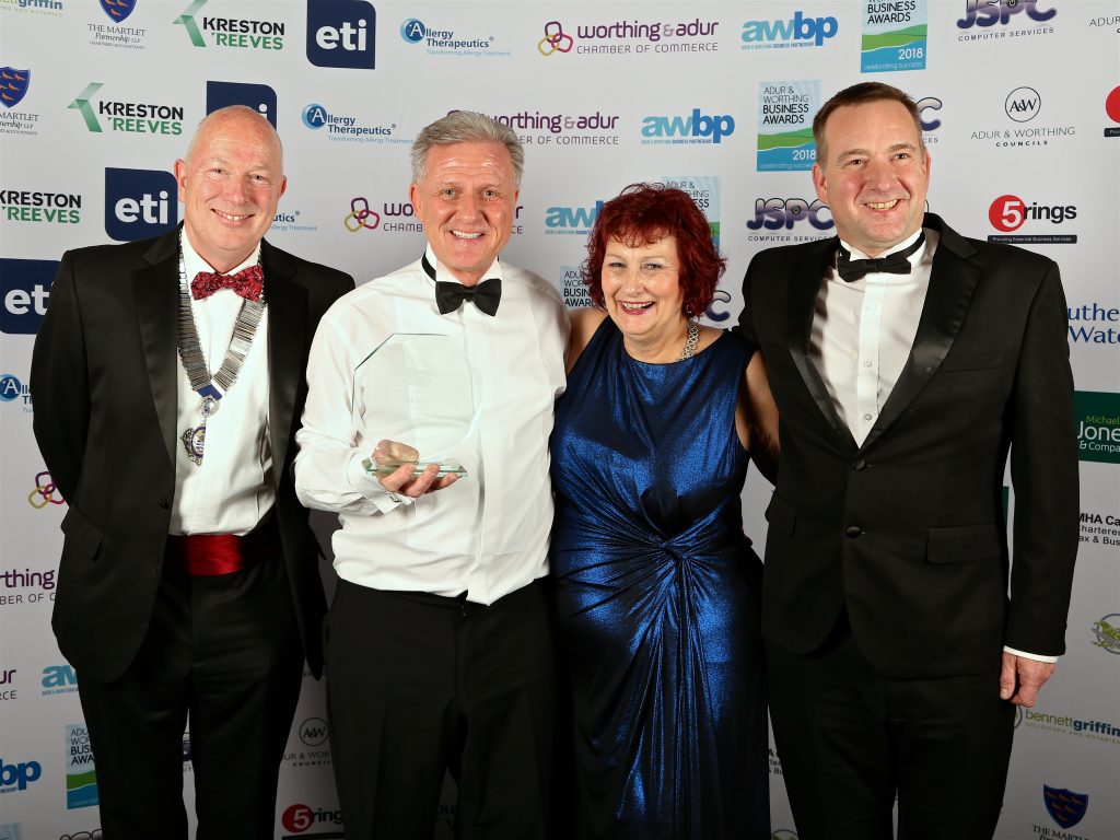 Photo shows members of the Wall Bros Carpets team standing with their award at the Adur and Worthing business awards 2018