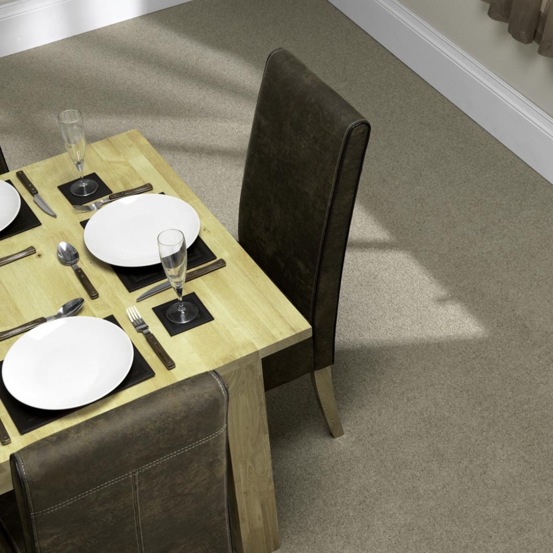 Photo shows a dining room with light brown carpet