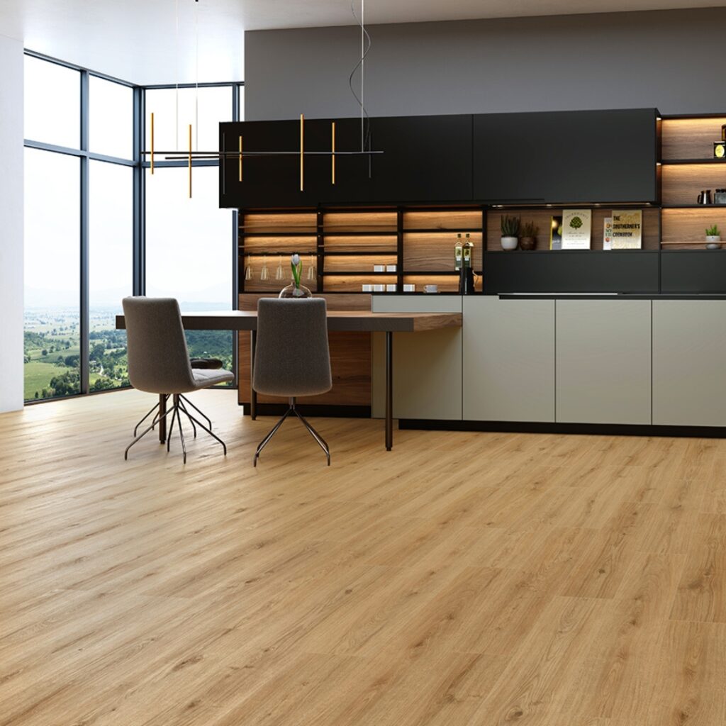 Photo shows a modern kitchen with a great view. Flooring is wood style laminate flooring which Wall Bros can supply
