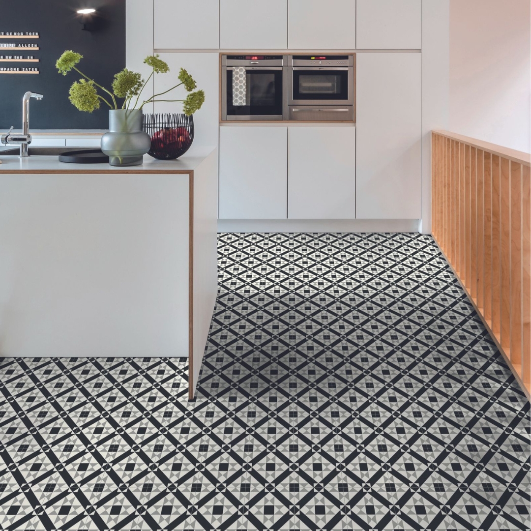 Photo shows a modern kitchen with a loud, patterned LVT flooring